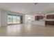 Bright living room and kitchen with tile floors, sliding glass doors, and neutral paint at 25319 N 131St Dr, Peoria, AZ 85383