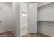 Walk-in closet leading to the primary bathroom with shower at 25319 N 131St Dr, Peoria, AZ 85383