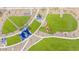 Overhead view of a manicured park featuring geometric grass designs, shade structures, and walking paths at 25324 N 131St Dr, Peoria, AZ 85383