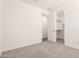 Bedroom featuring soft carpet and two doorways to closet and hallway at 25324 N 131St Dr, Peoria, AZ 85383