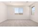 Bright bedroom featuring natural lighting from two windows and neutral walls at 25324 N 131St Dr, Peoria, AZ 85383