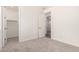 Neutral bedroom with a doorway leading to the walk-in closet and a carpeted floor at 25324 N 131St Dr, Peoria, AZ 85383
