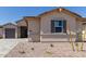 A quaint new home with a desert landscape and neutral-colored exterior paint at 25324 N 131St Dr, Peoria, AZ 85383