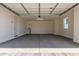 Spacious garage with a concrete floor, water heater, access door, window and an automatic garage door at 25324 N 131St Dr, Peoria, AZ 85383