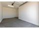 Spacious garage with a concrete floor, access door to the house, garage door opener and lots of wall space at 25324 N 131St Dr, Peoria, AZ 85383