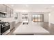 Open-concept kitchen showcasing a central island and stainless steel appliances at 25324 N 131St Dr, Peoria, AZ 85383