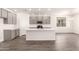Bright kitchen with a central island, modern appliances, and wood-look tile flooring at 25324 N 131St Dr, Peoria, AZ 85383