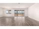 Open-concept living room with tile floors and natural light from large sliding glass doors at 25324 N 131St Dr, Peoria, AZ 85383