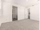 Carpeted primary bedroom with doorway to ensuite bathroom and walk-in closet at 25324 N 131St Dr, Peoria, AZ 85383