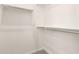 Bright walk-in closet with carpet flooring, metal hanging rods, and white walls ready to be organized at 25324 N 131St Dr, Peoria, AZ 85383
