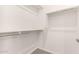 Bright walk-in closet with carpet flooring, metal hanging rods, and white walls ready to be organized at 25324 N 131St Dr, Peoria, AZ 85383