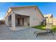 A backyard features a covered patio, a small patch of artificial turf, and a stylish chaise lounge at 2629 E Hidalgo Ave, Phoenix, AZ 85040