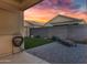 Private covered patio with artificial grass, pavers, and lounge chair under a colorful sunset at 2629 E Hidalgo Ave, Phoenix, AZ 85040