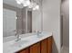 A spacious bathroom features a double sink vanity with wood cabinets and a large mirror at 2629 E Hidalgo Ave, Phoenix, AZ 85040
