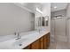 Bathroom with dual sinks, large mirror, and shower and tub combo at 2629 E Hidalgo Ave, Phoenix, AZ 85040