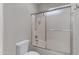 Bathroom with tub and shower features sliding glass doors and a shower head at 2629 E Hidalgo Ave, Phoenix, AZ 85040