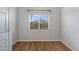 Bright, window-lit bedroom boasts laminate wood flooring and neutral decor at 2629 E Hidalgo Ave, Phoenix, AZ 85040