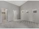 A neutral bedroom features light gray walls, plush carpeting, and windows with blinds for natural light at 2629 E Hidalgo Ave, Phoenix, AZ 85040