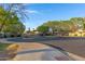 Community entrance with trees and landscape at 2629 E Hidalgo Ave, Phoenix, AZ 85040