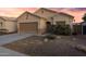 Inviting single Gathering home with a two car garage and desert landscaping under a colorful sunset at 2629 E Hidalgo Ave, Phoenix, AZ 85040
