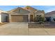 Charming single-story home featuring a two-car garage, desert landscaping, and a cozy front porch at 2629 E Hidalgo Ave, Phoenix, AZ 85040