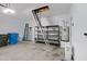 A spacious, well-lit garage with attic access, featuring storage solutions and epoxy flooring at 2629 E Hidalgo Ave, Phoenix, AZ 85040