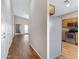 Hallway view of kitchen and open floor plan featuring wood-look flooring and neutral paint colors at 2629 E Hidalgo Ave, Phoenix, AZ 85040