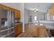 The kitchen features stainless steel refrigerator and appliances, wooden cabinets, and an open layout at 2629 E Hidalgo Ave, Phoenix, AZ 85040
