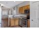 Well-lit kitchen features wooden cabinets, stainless steel appliances, and an efficient layout at 2629 E Hidalgo Ave, Phoenix, AZ 85040