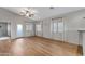 Spacious living room featuring wood-look flooring, neutral colors, and natural light from large windows at 2629 E Hidalgo Ave, Phoenix, AZ 85040