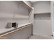 A large walk-in closet featuring built-in shelving and hanging rods provides ample storage space at 2629 E Hidalgo Ave, Phoenix, AZ 85040