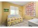 Cozy bedroom featuring a daybed and a colorful quilt wall hanging at 26456 W Cat Balue Dr, Buckeye, AZ 85396