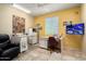 Comfortable bedroom with desk areas, a recliner and a mounted television at 26456 W Cat Balue Dr, Buckeye, AZ 85396
