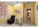 Bedroom with a work station, a comfortable chair and natural lighting at 26456 W Cat Balue Dr, Buckeye, AZ 85396