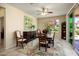 Cozy dining room with neutral walls, lots of light, ceiling fan, and an adjacent patio at 26456 W Cat Balue Dr, Buckeye, AZ 85396