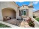Inviting entryway with seating, desert landscaping, and stone tile walkway at 26456 W Cat Balue Dr, Buckeye, AZ 85396