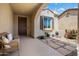 Cozy front porch with neutral decor and flagstone accents at 26456 W Cat Balue Dr, Buckeye, AZ 85396