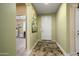 Inviting foyer with a view into an office and tile flooring at 26456 W Cat Balue Dr, Buckeye, AZ 85396