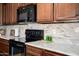 Close-up of modern kitchen appliances, countertops and stylish backsplash tile at 26456 W Cat Balue Dr, Buckeye, AZ 85396