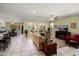 Open-concept living room features tile floors and comfortable seating at 26456 W Cat Balue Dr, Buckeye, AZ 85396