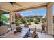 Covered patio with dining table overlooking landscaped backyard at 26456 W Cat Balue Dr, Buckeye, AZ 85396