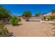 A large desert landscaped backyard with a pool and patio area at 29703 N 70Th Ave, Peoria, AZ 85383