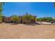 A house with an outdoor dining area and a desert landscaped backyard at 29703 N 70Th Ave, Peoria, AZ 85383