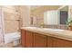 Bathroom with a double sink vanity and a shower-tub combination is both functional and stylish at 29703 N 70Th Ave, Peoria, AZ 85383