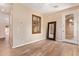 Bright bedroom featuring hard wood flooring, neutral paint, and large mirror at 29703 N 70Th Ave, Peoria, AZ 85383
