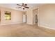 Large bedroom with carpet, ceiling fan, and ensuite bathroom access at 29703 N 70Th Ave, Peoria, AZ 85383