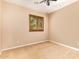 Neutral bedroom featuring a window for natural light and a ceiling fan with a light at 29703 N 70Th Ave, Peoria, AZ 85383