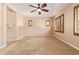 Neutral bedroom with carpet, ceiling fan, and shuttered windows at 29703 N 70Th Ave, Peoria, AZ 85383
