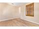 Minimalist bedroom with wood flooring, lots of light, and neutral colors at 29703 N 70Th Ave, Peoria, AZ 85383