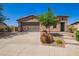 Charming single-story home with a well-manicured front yard, desert landscaping, and a three-car garage at 29703 N 70Th Ave, Peoria, AZ 85383